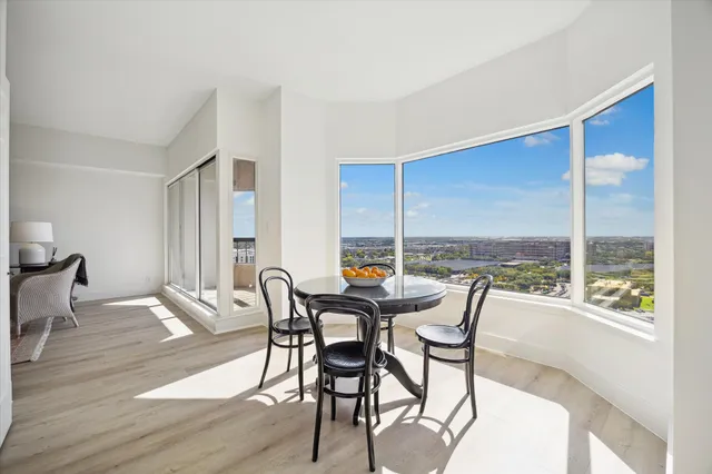 a dining room with furniture and wooden floor