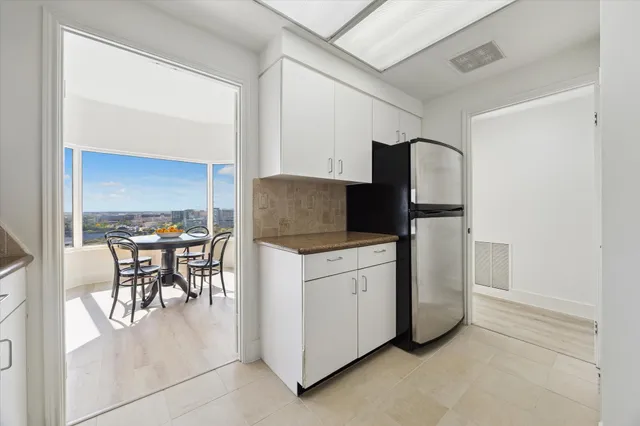 a kitchen with cabinets and chairs
