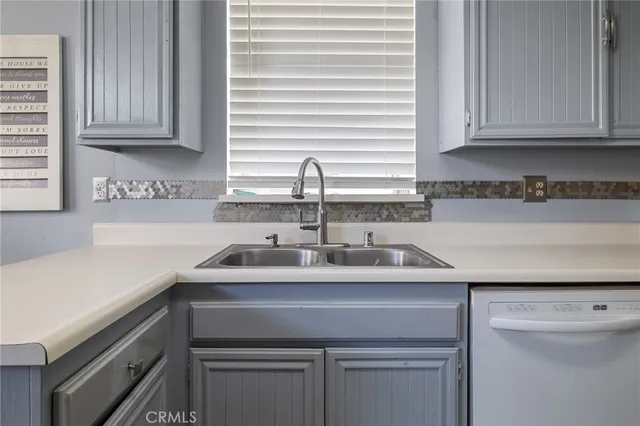 a kitchen with a sink cabinets and window