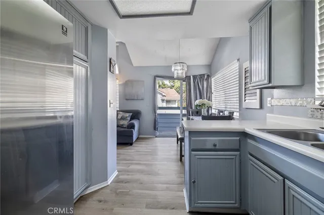 a kitchen with a sink and refrigerator