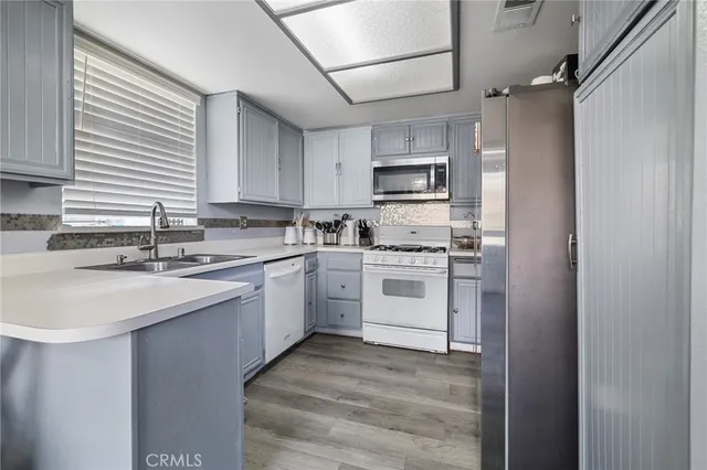 a kitchen with appliances cabinets and a sink