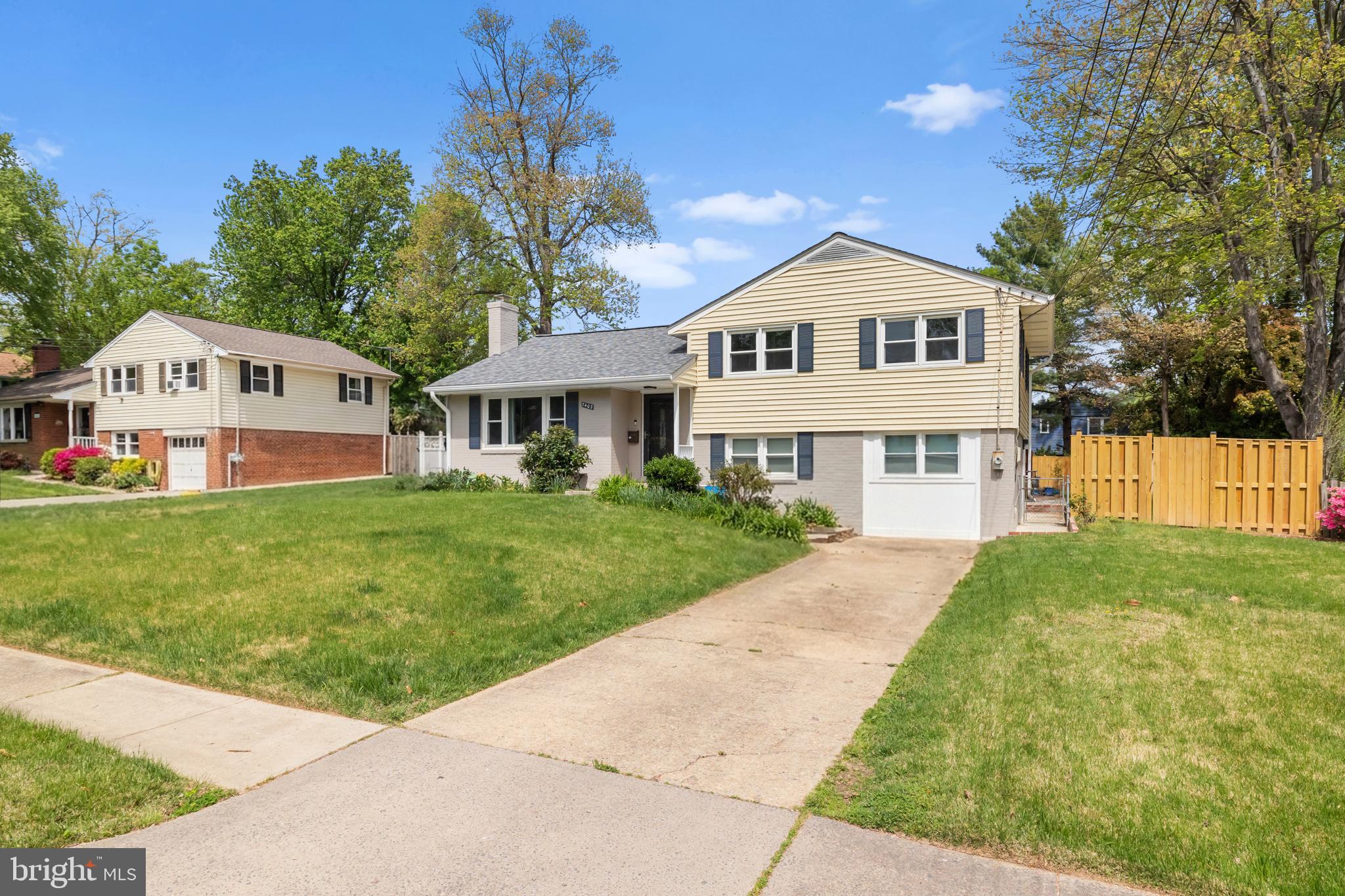 7402 Dunston Street Springfield, VA 22151 - Photo 2 of 37 a view of house with garden and tall trees