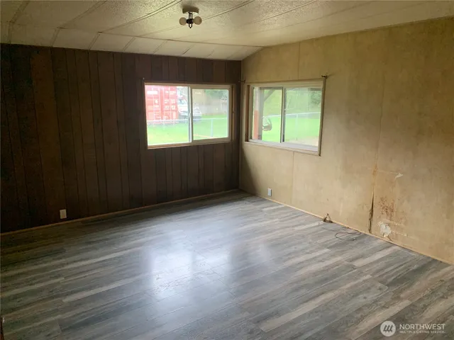 a view of a house with backyard and porch