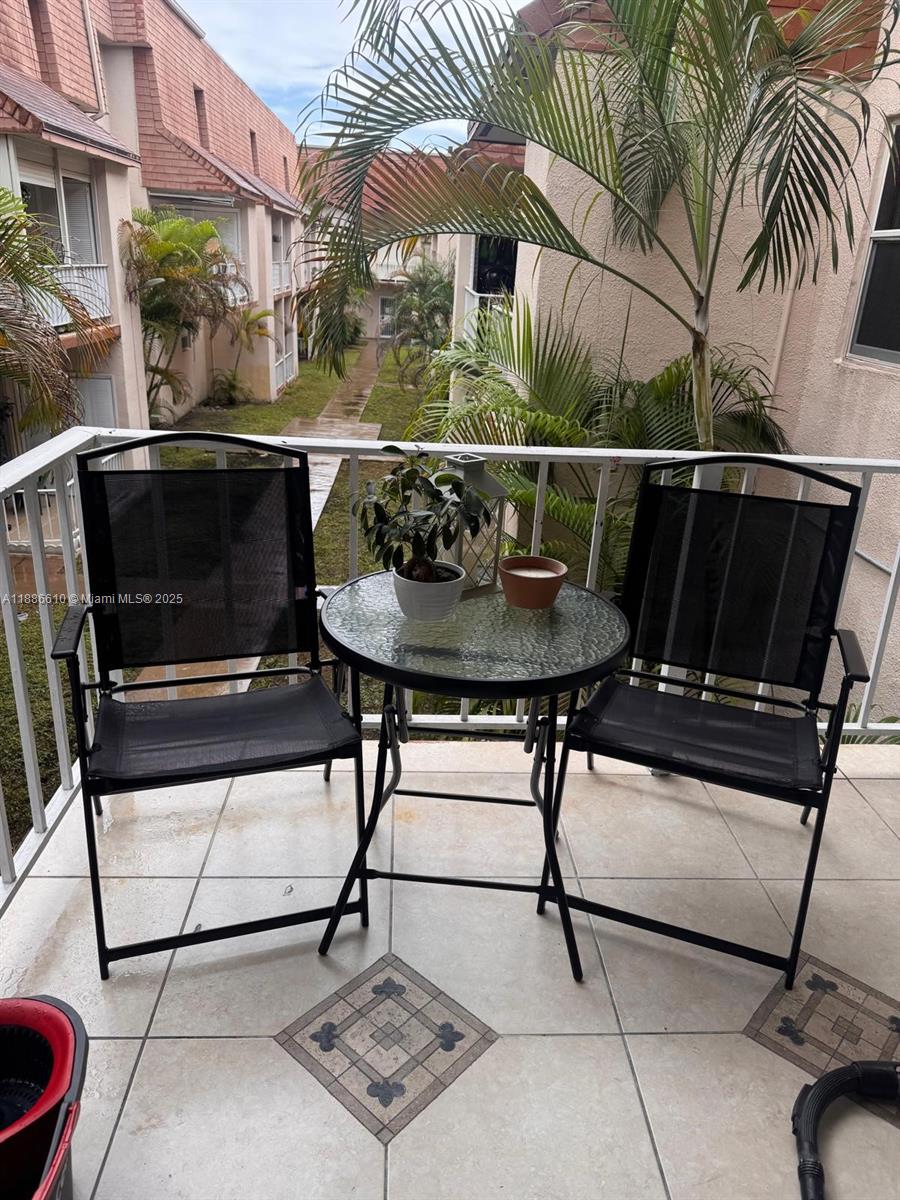 1560 West 46th Street, Unit 236 Hialeah, FL 33012 - Photo 13 of 19 a view of a chairs and table in the patio