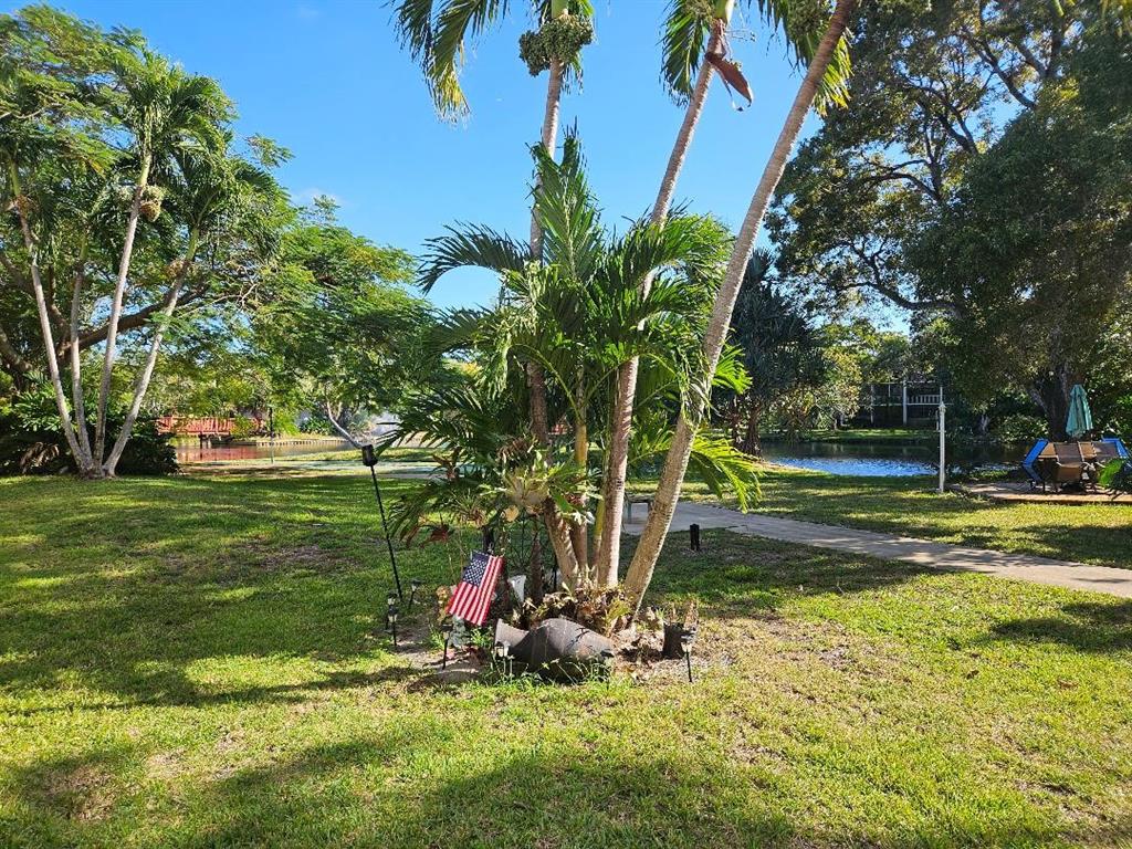 777 Southeast 2nd Avenue, Unit D123 Deerfield Beach, FL 33441 - Photo 13 of 36 a view of a park with large trees