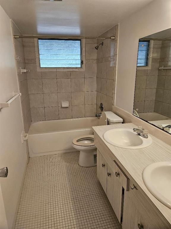 777 Southeast 2nd Avenue, Unit D123 Deerfield Beach, FL 33441 - Photo 14 of 36 a bathroom with a granite countertop sink a toilet a mirror and bathtub