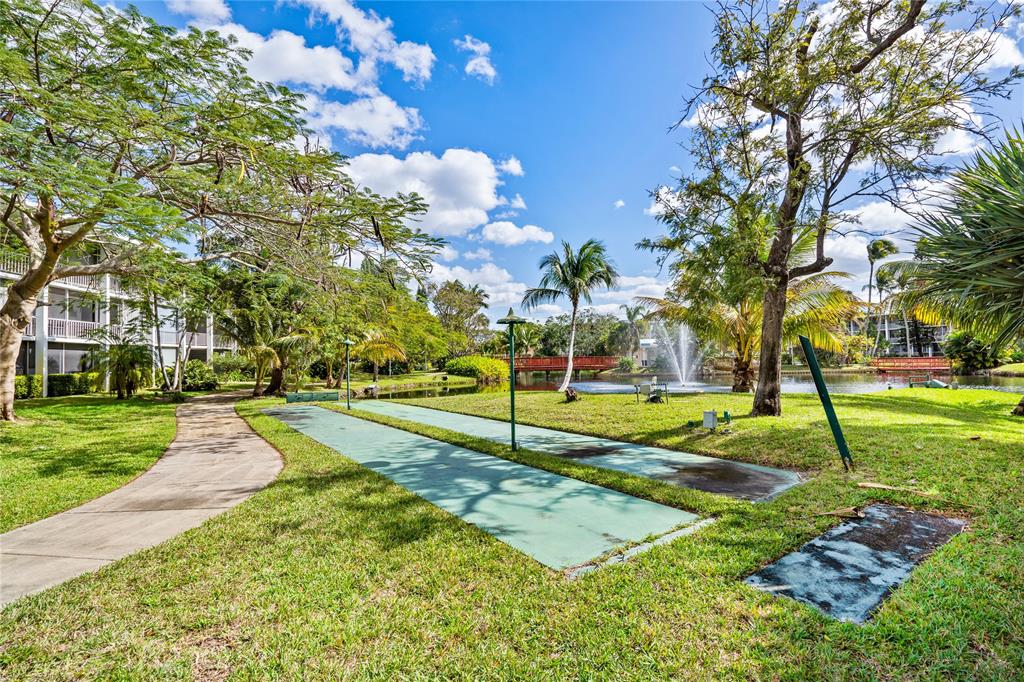 777 Southeast 2nd Avenue, Unit D123 Deerfield Beach, FL 33441 - Photo 21 of 36 a view of a playground with basketball court