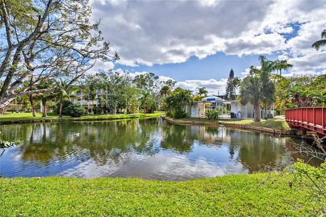 a view of a lake with a yard and mountain