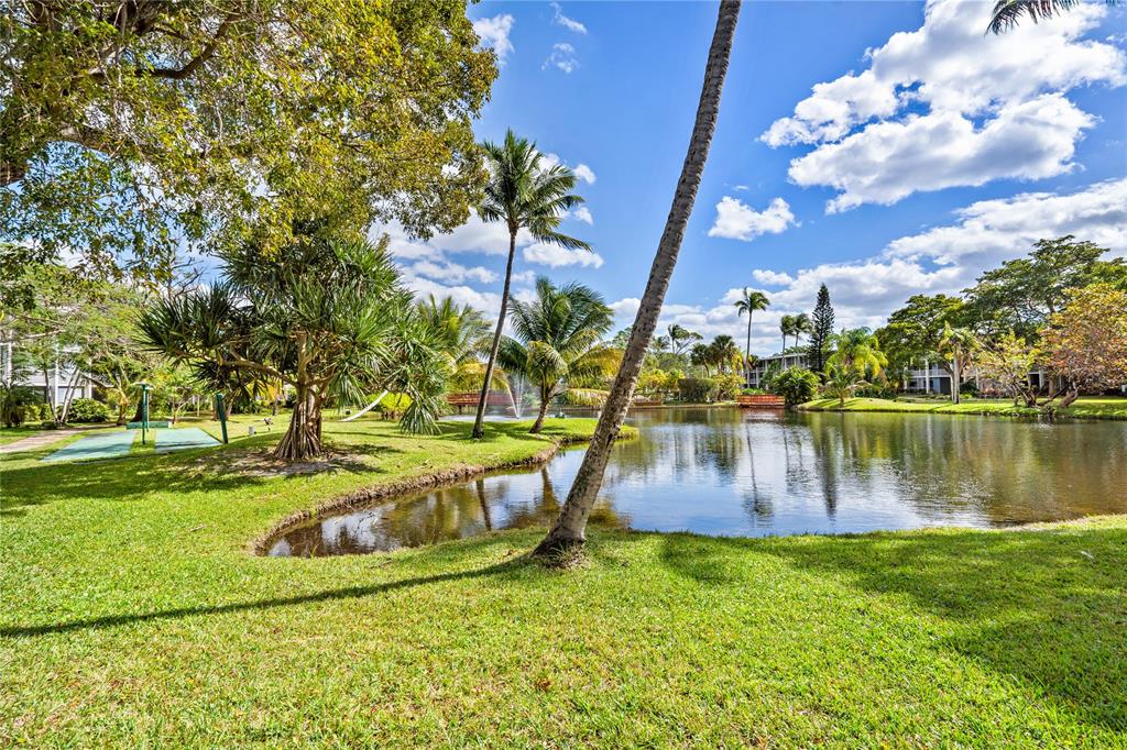 777 Southeast 2nd Avenue, Unit D123 Deerfield Beach, FL 33441 - Photo 29 of 36 a view of a garden with swimming pool