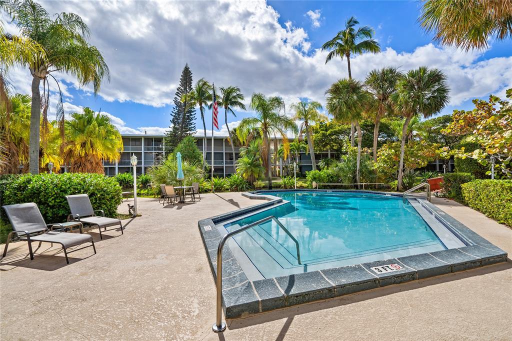 777 Southeast 2nd Avenue, Unit D123 Deerfield Beach, FL 33441 - Photo 31 of 36 a swimming pool with outdoor seating and yard