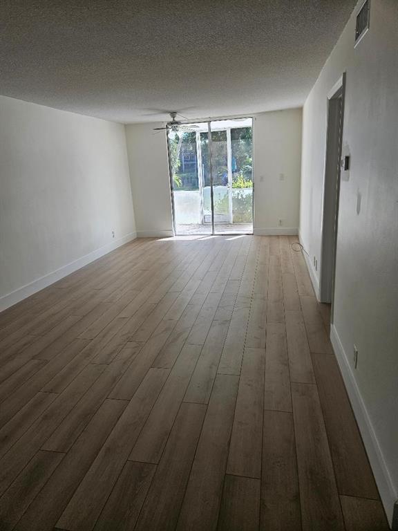 777 Southeast 2nd Avenue, Unit D123 Deerfield Beach, FL 33441 - Photo 5 of 36 wooden floor in an empty room with a window