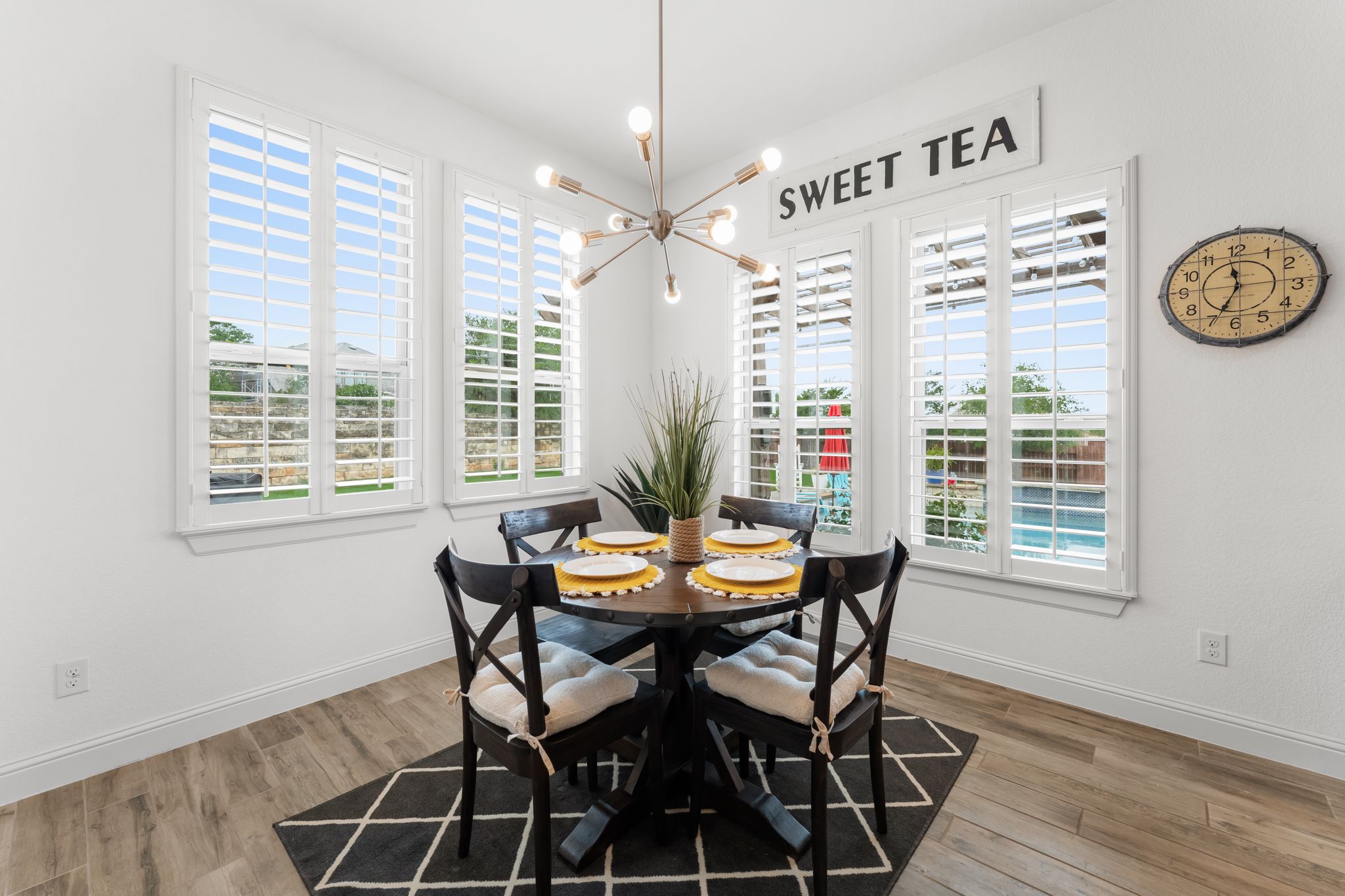140 Waterloo Cove Georgetown, TX 78628 - Photo 13 of 40 A charming dining area features crisp white plantation shutters, rich wood-look flooring, and a contemporary light fixture.