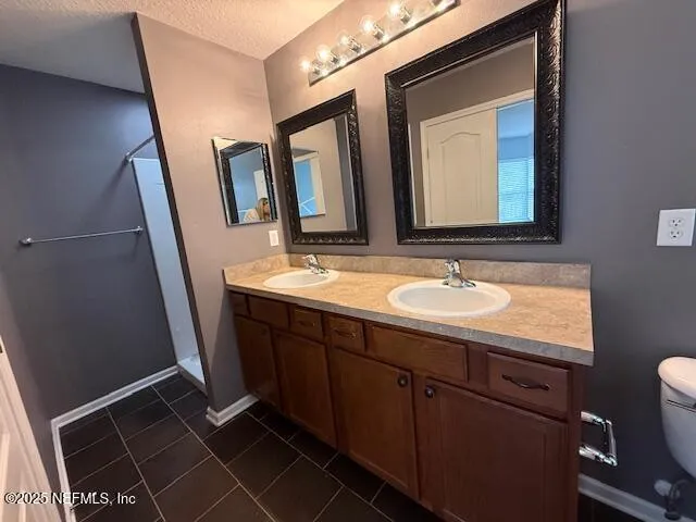a bathroom with a double vanity sink and mirror