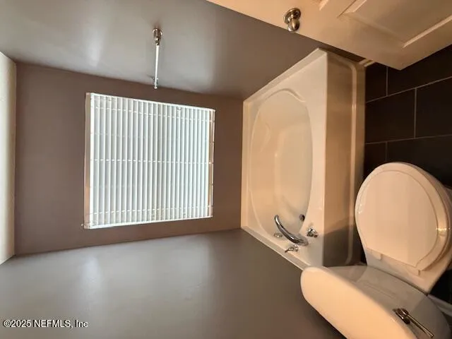 a view of a livingroom with furniture wooden floor and windows