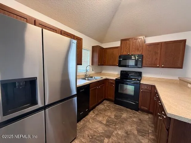 a kitchen with a refrigerator stove and sink