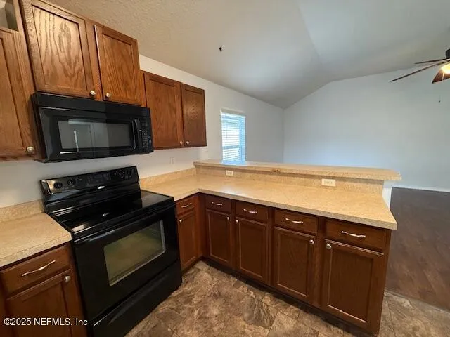a kitchen with wooden cabinets and a stove top oven