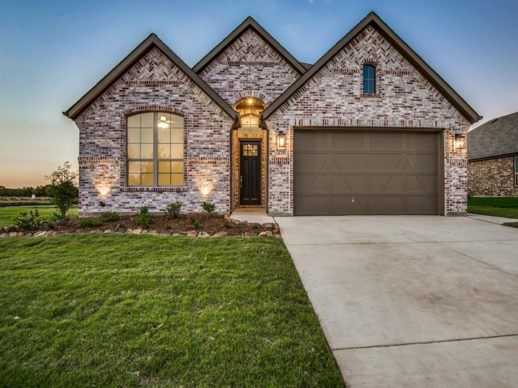 139 Lakeview Circle Pilot Point, TX 76258 - Photo 17 of 19 Example of same Thackery Custom Home floorpan with Brick facade featuring stone accents, a two-car garage, and a covered entry