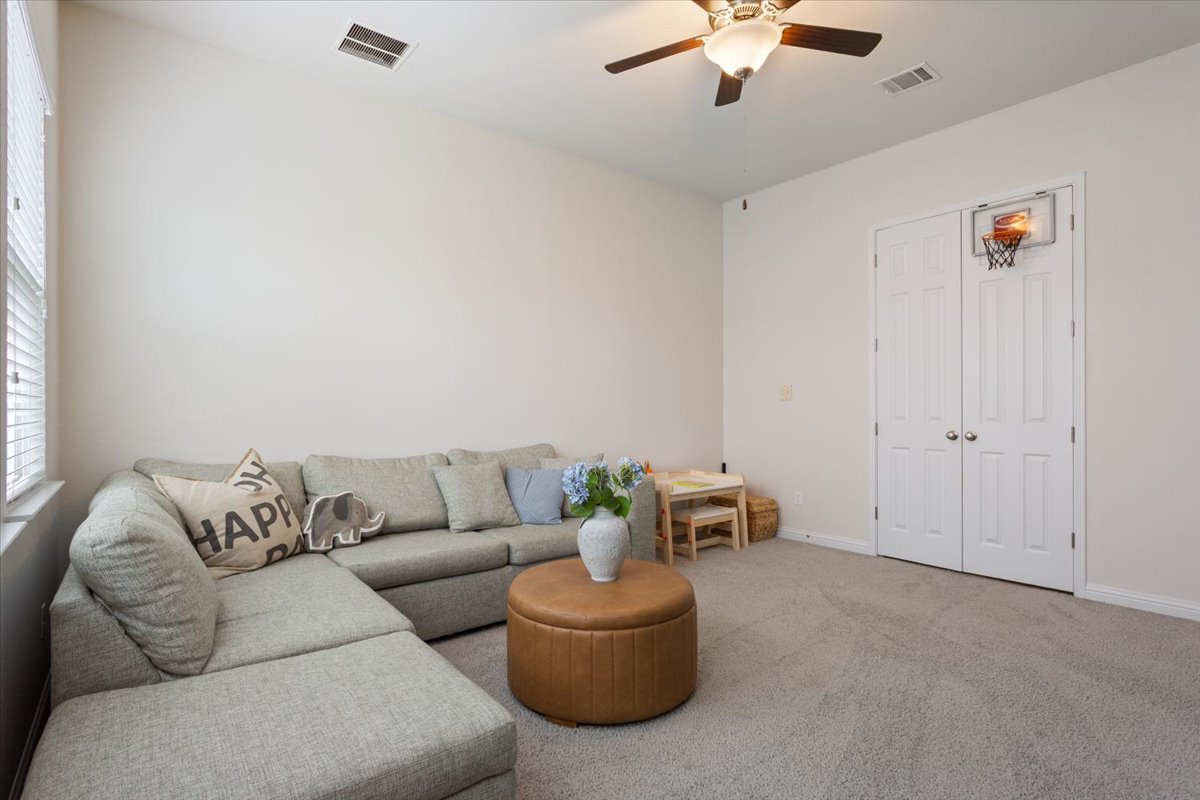 424 Millard Street Georgetown, TX 78628 - Photo 28 of 37 Relax in this well-lit living area featuring high ceilings and soft carpeting.