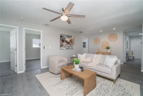 a living room with furniture and wooden floor