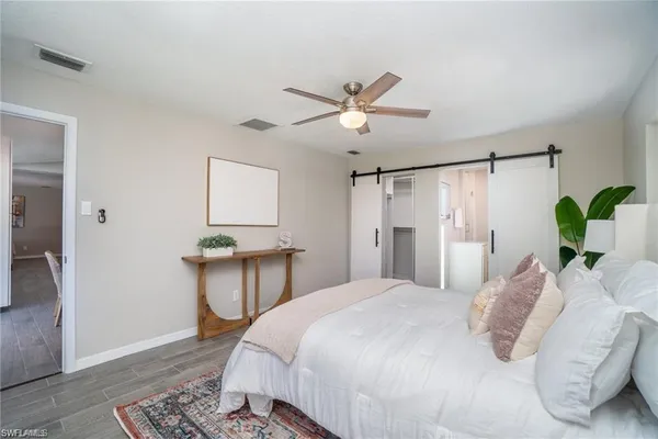 a bedroom with a bed dresser and a window