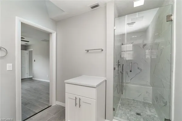 a bathroom with a shower and sink