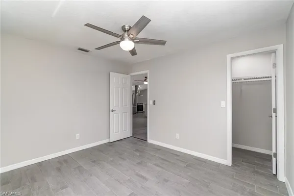 a view of an empty room and closet area