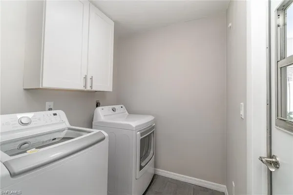 a view of washer and dryer with kitchen in the background