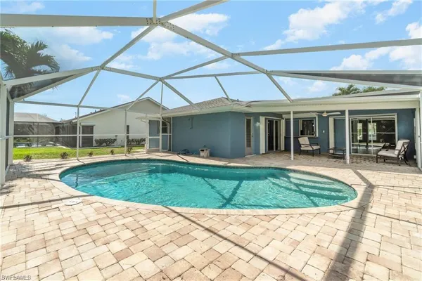 a view of a white house with swimming pool