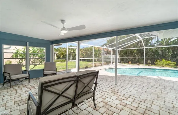 a view of a dining room with furniture large windows and wooden floor