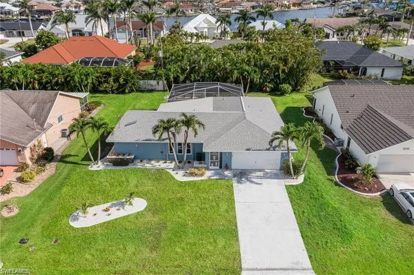 an aerial view of a house with swimming pool garden and patio