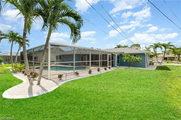a view of a house with backyard and sitting area