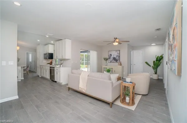 a living room with furniture and kitchen view