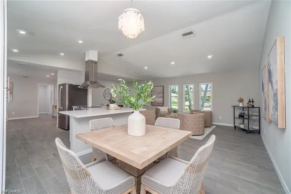 a dining room with furniture a window and wooden floor