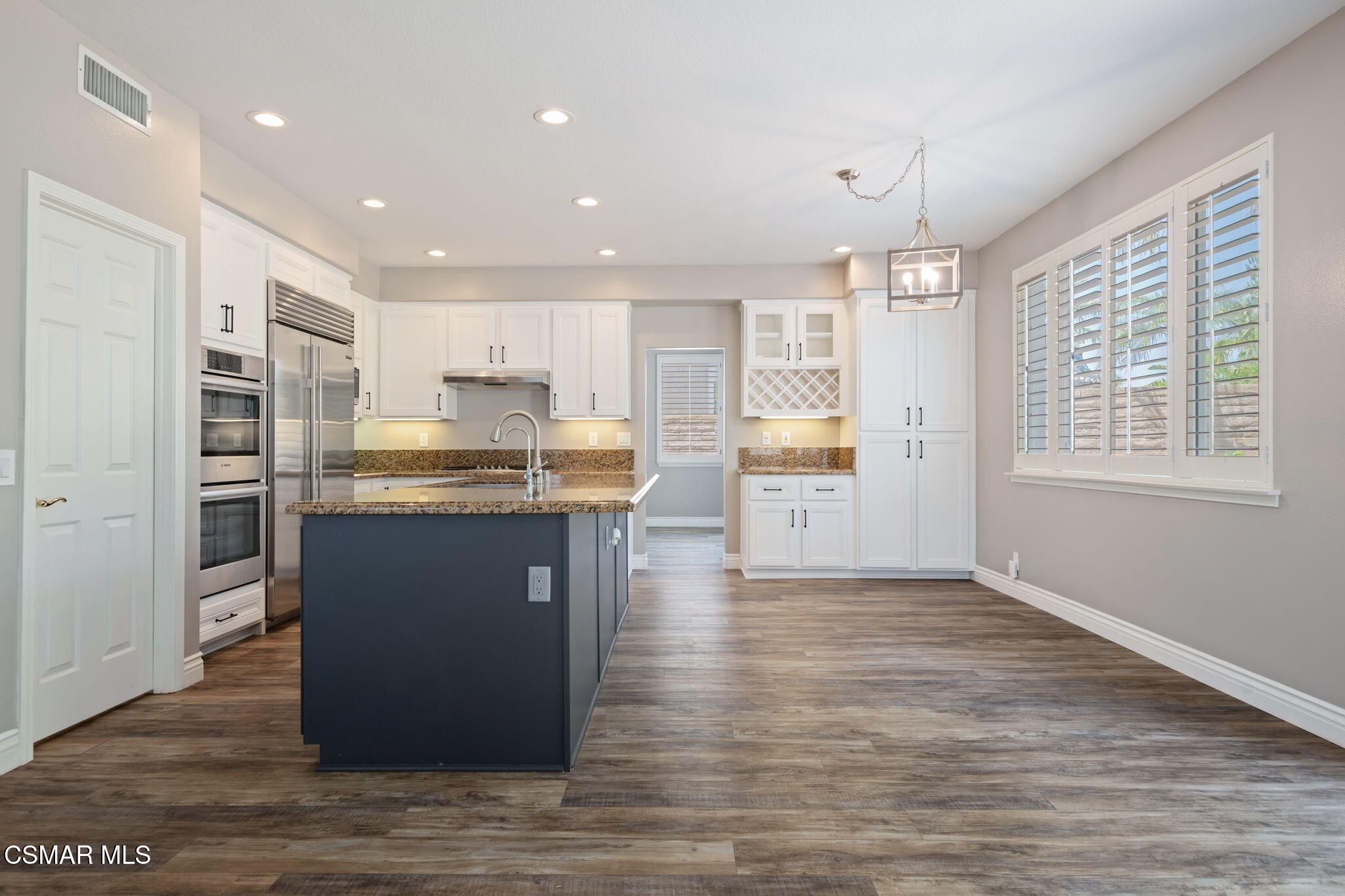 335 Kitetail Street Simi Valley, CA 93065 - Photo 14 of 53 a kitchen with stainless steel appliances granite countertop a refrigerator a sink dishwasher and a stove with wooden floor