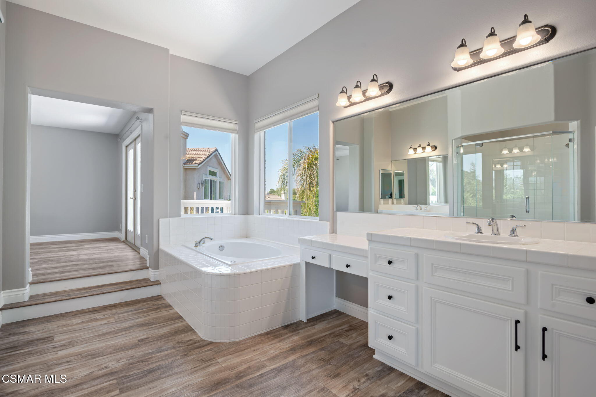 335 Kitetail Street Simi Valley, CA 93065 - Photo 29 of 53 a spacious bathroom with a tub double sink and a mirror