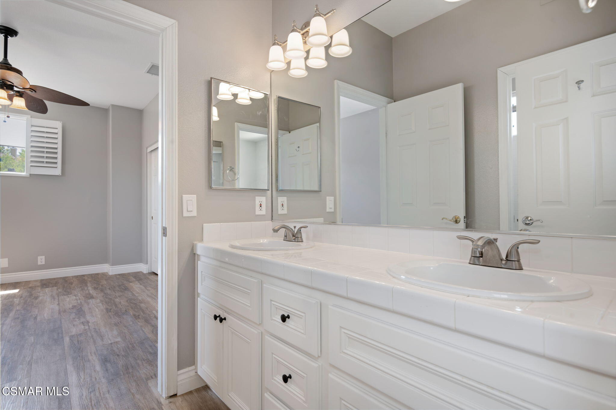 335 Kitetail Street Simi Valley, CA 93065 - Photo 39 of 53 a bathroom with double vanity sink a vanity and mirrors