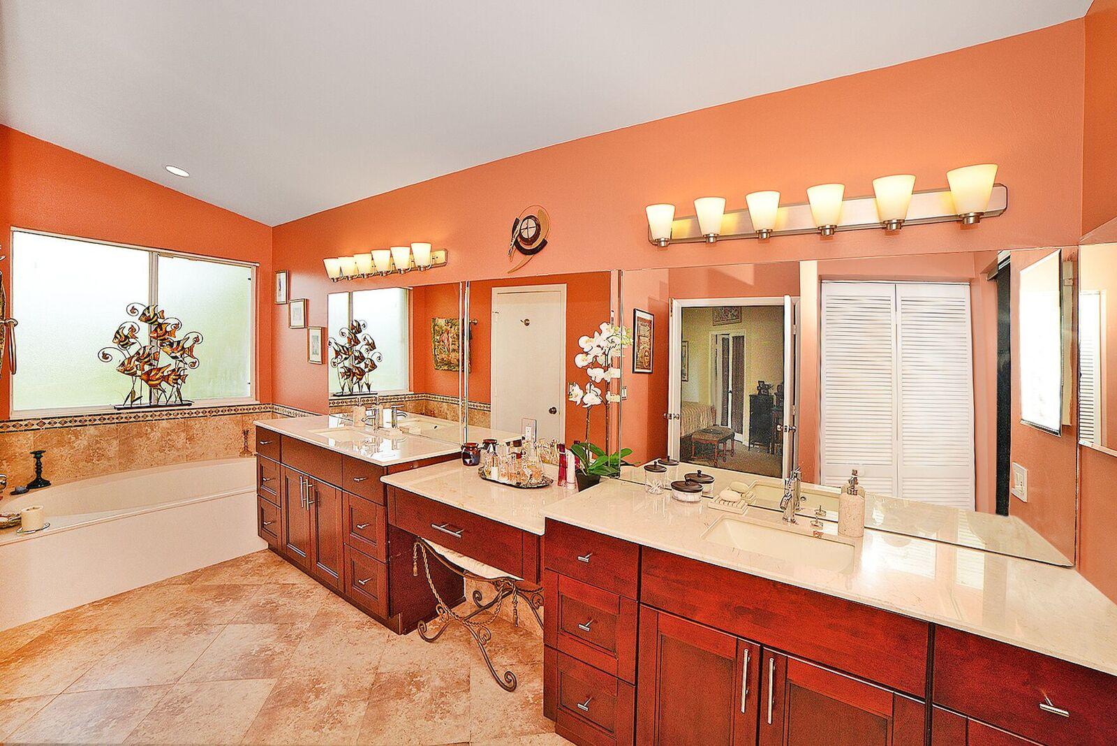 11140 Sandpoint Terrace Boca Raton, FL 33428 - Photo 17 of 32 a spacious bathroom with a double vanity sink a large mirror and a bathtub