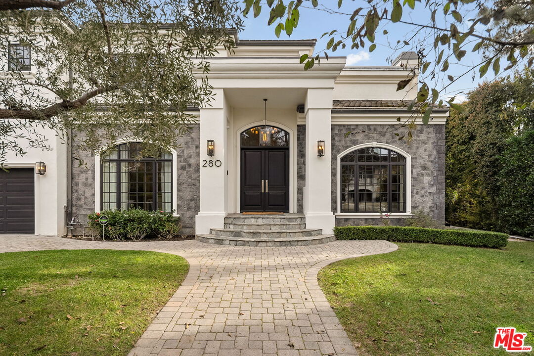 280 Homewood Road Los Angeles, CA 90049 - Photo 1 of 1 a front view of a house with garden