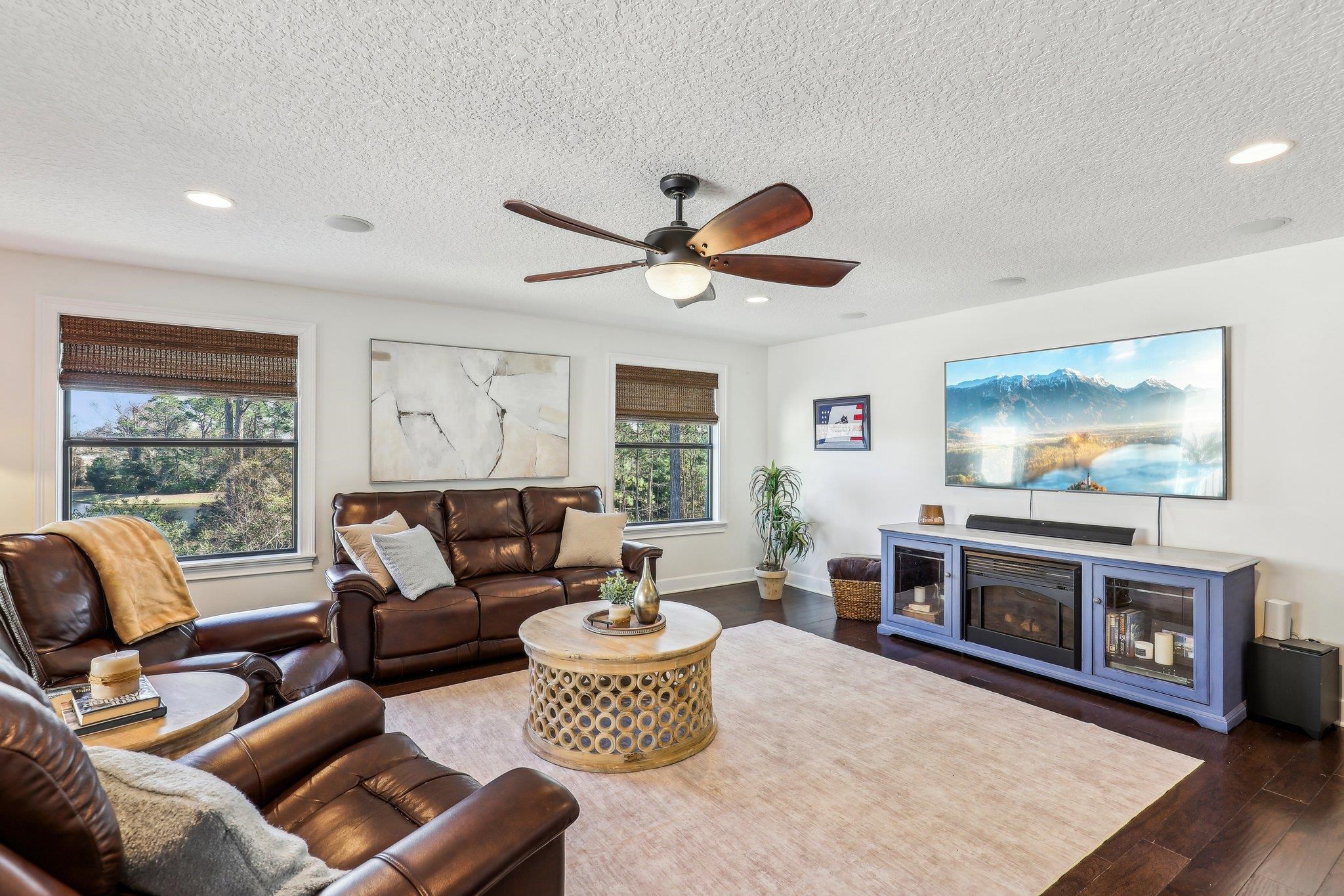 152 Spanish Marsh Drive St. Augustine, FL 32095 - Photo 23 of 63 a living room with furniture a flat screen tv and a fireplace