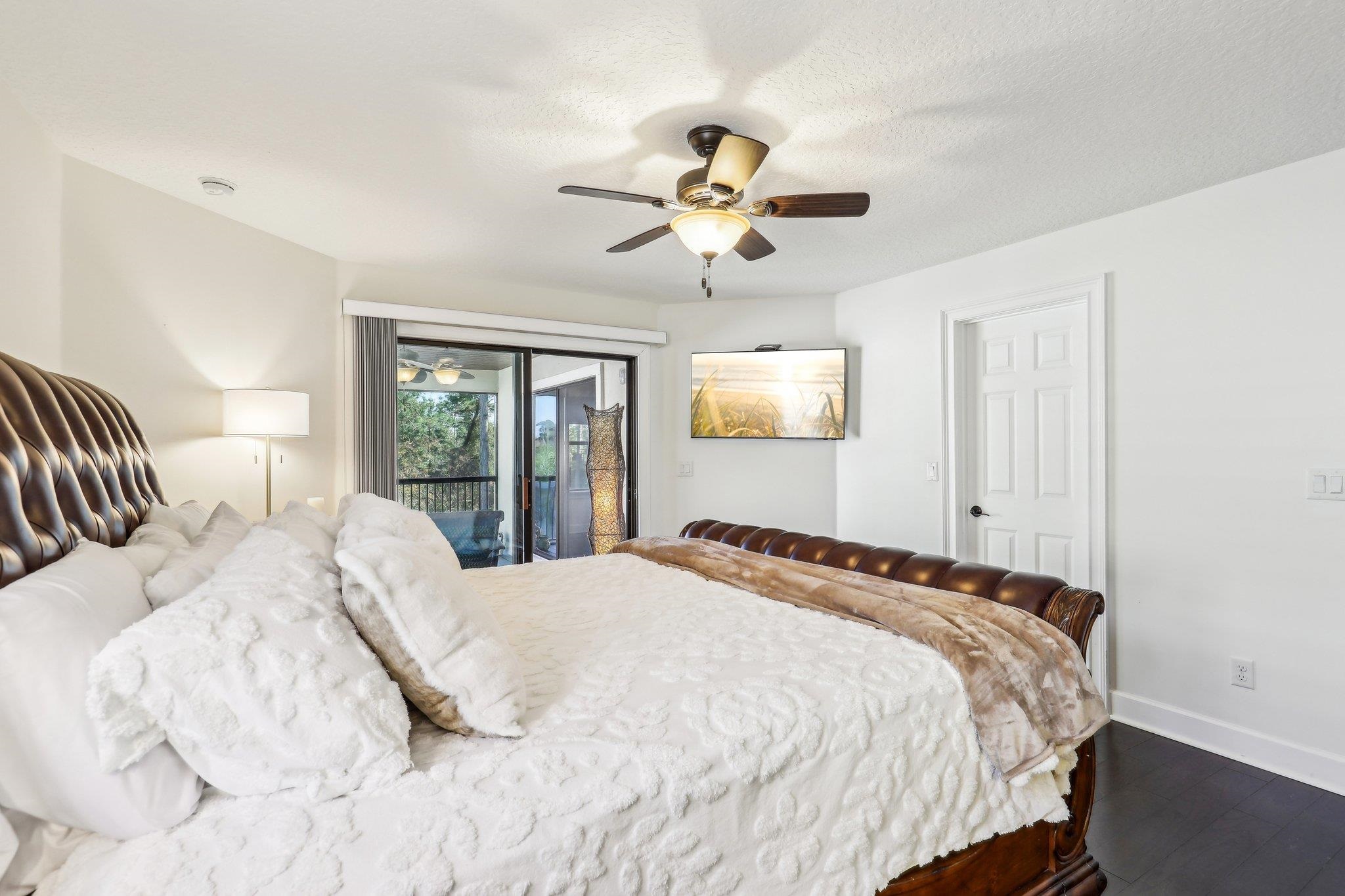 152 Spanish Marsh Drive St. Augustine, FL 32095 - Photo 25 of 63 a bedroom with a large bed and a chandelier