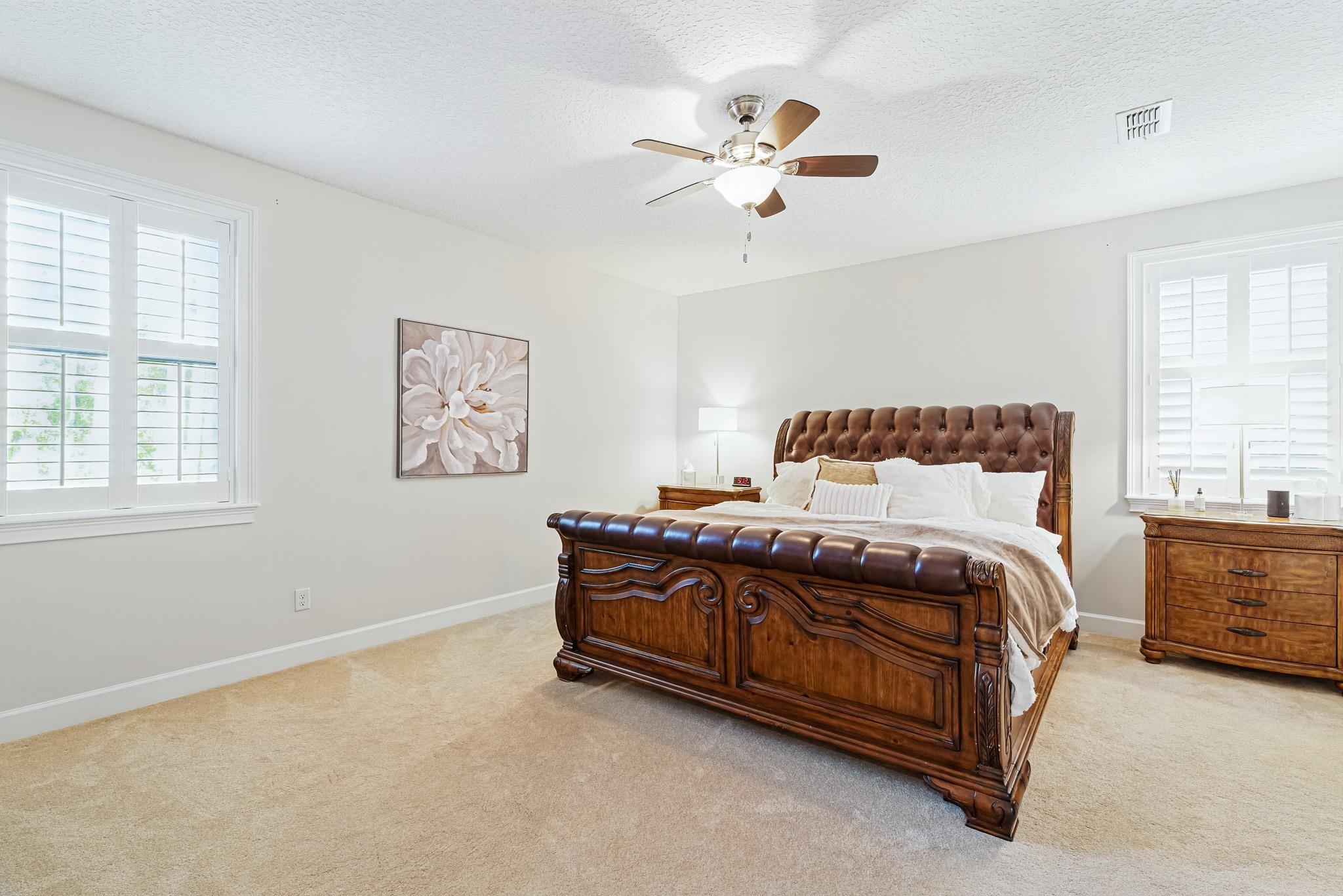 152 Spanish Marsh Drive St. Augustine, FL 32095 - Photo 50 of 63 a bedroom with a bed chandelier and window