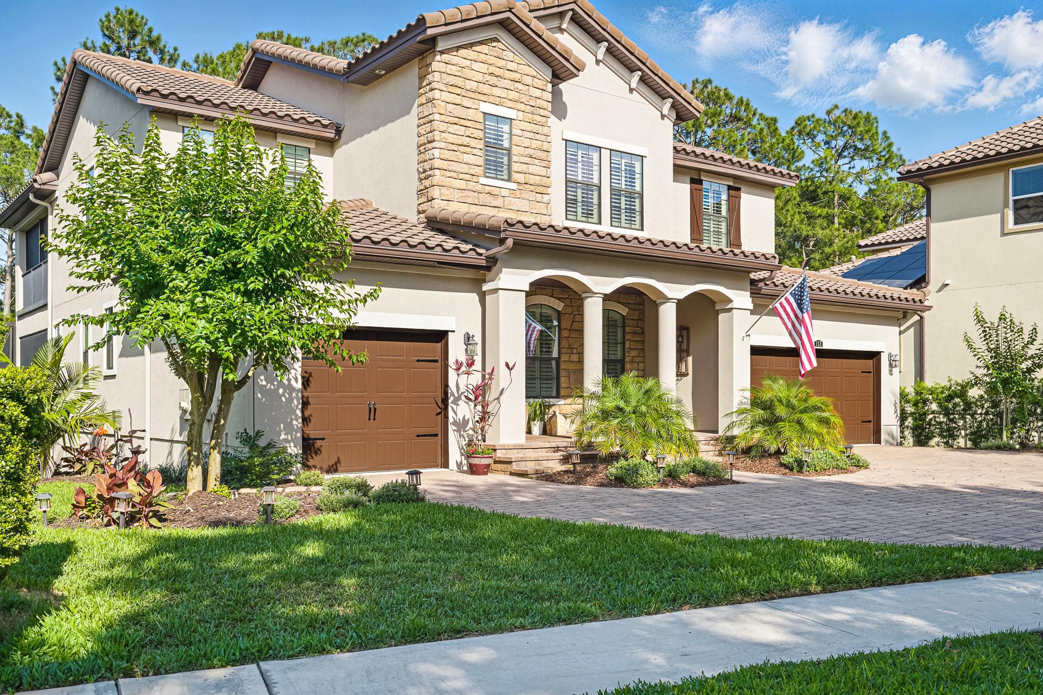152 Spanish Marsh Drive St. Augustine, FL 32095 - Photo 63 of 63 a front view of a house with a garden and plants