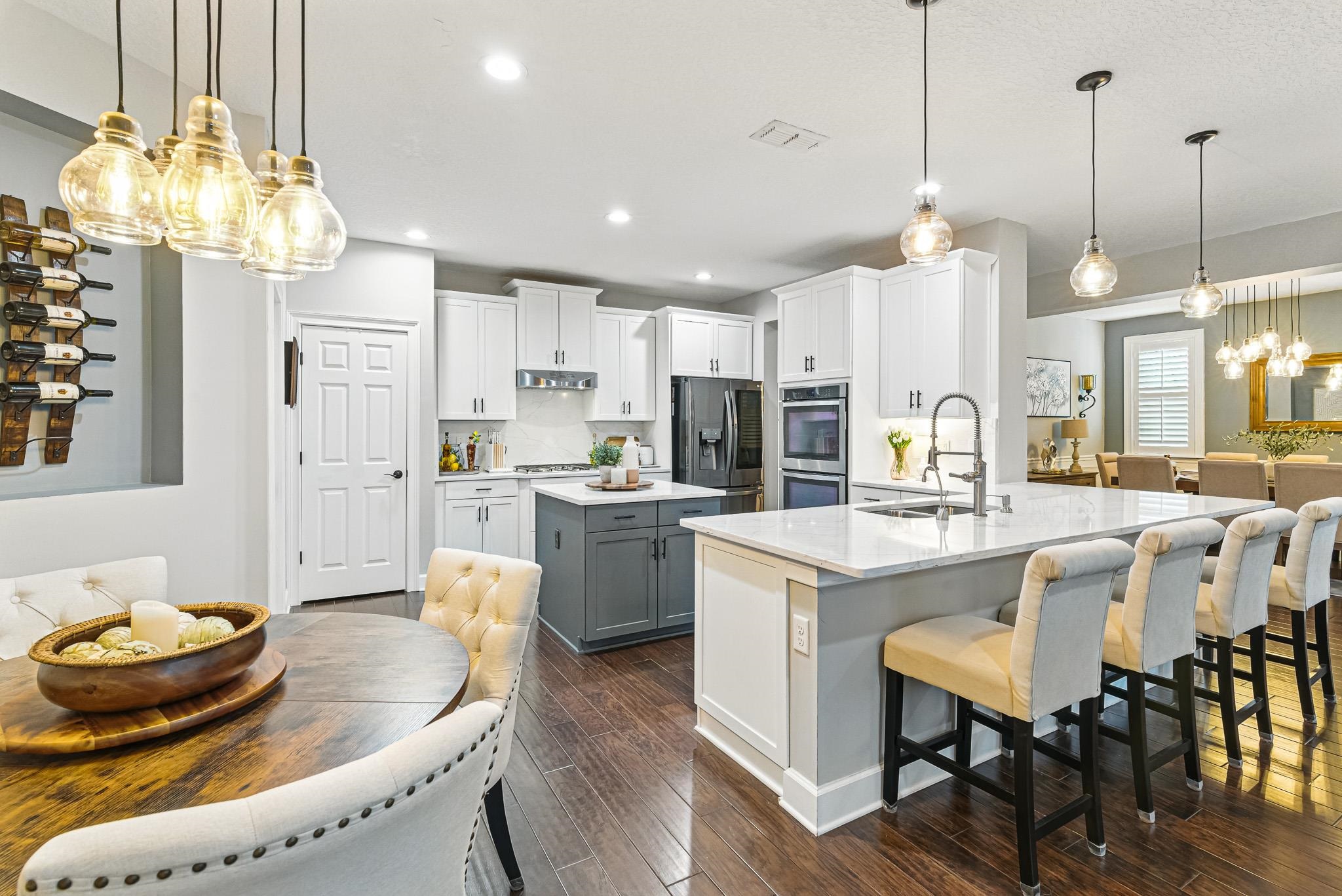 152 Spanish Marsh Drive St. Augustine, FL 32095 - Photo 9 of 63 a large kitchen with a table and chairs