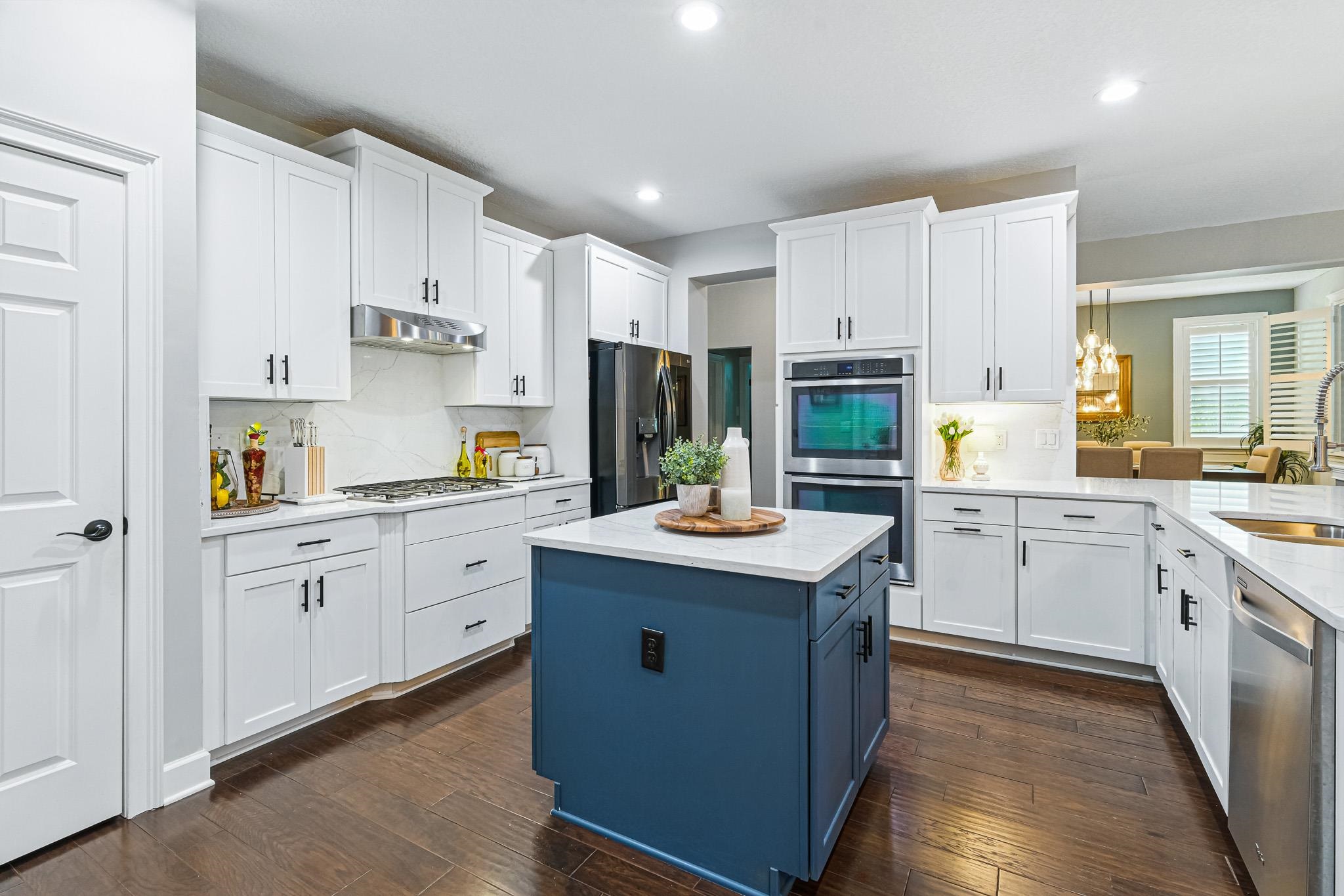152 Spanish Marsh Drive St. Augustine, FL 32095 - Photo 10 of 63 a kitchen with stainless steel appliances kitchen island granite countertop a sink stove and refrigerator