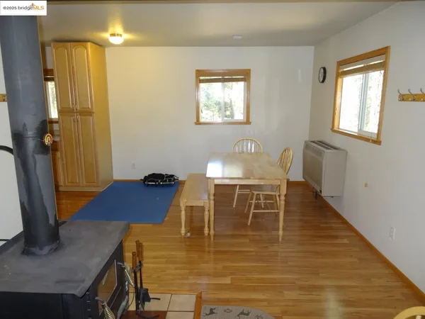 a dining room with furniture and wooden floor