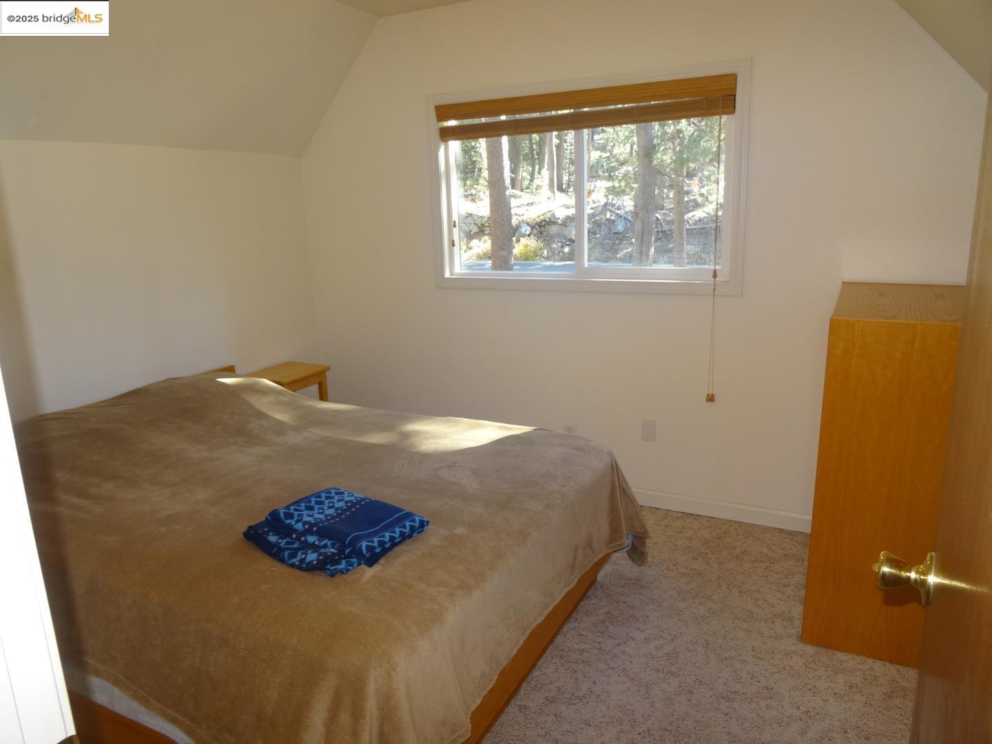 51468 Donner Pass Road Soda Springs, CA 95728 - Photo 19 of 22 a bedroom with a bed and wooden floor