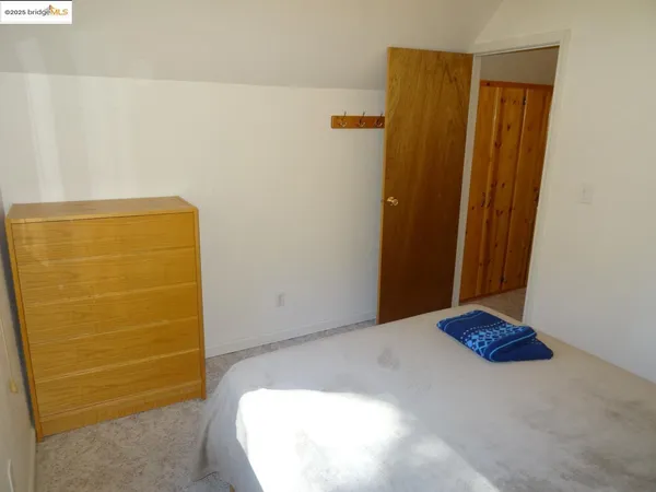 a bedroom with a bed and utility room