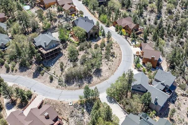 an aerial view of a house with a swimming pool