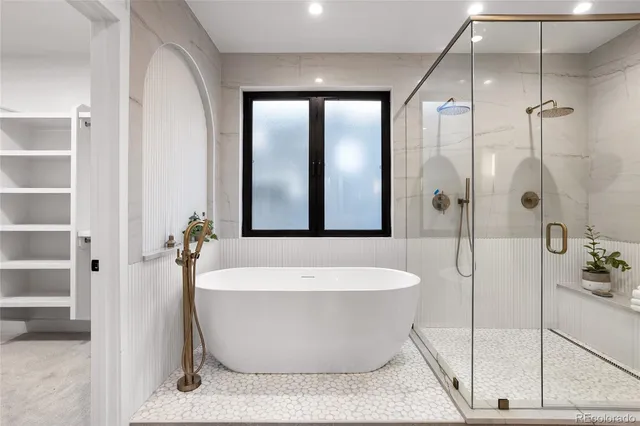 a bathroom with a bathtub and shower