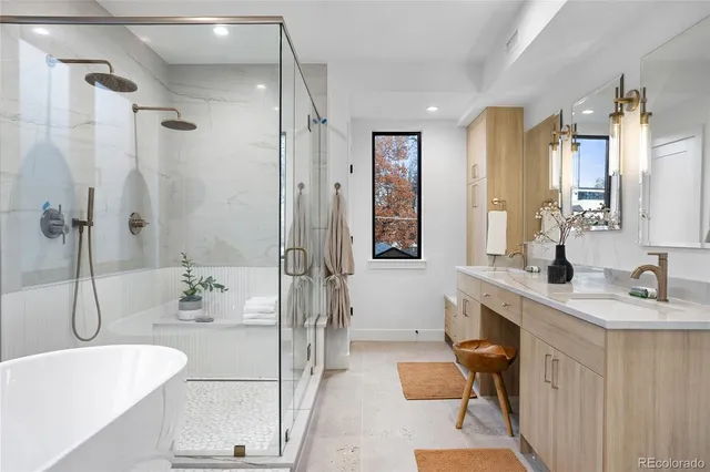a bathroom with a tub sink and mirror